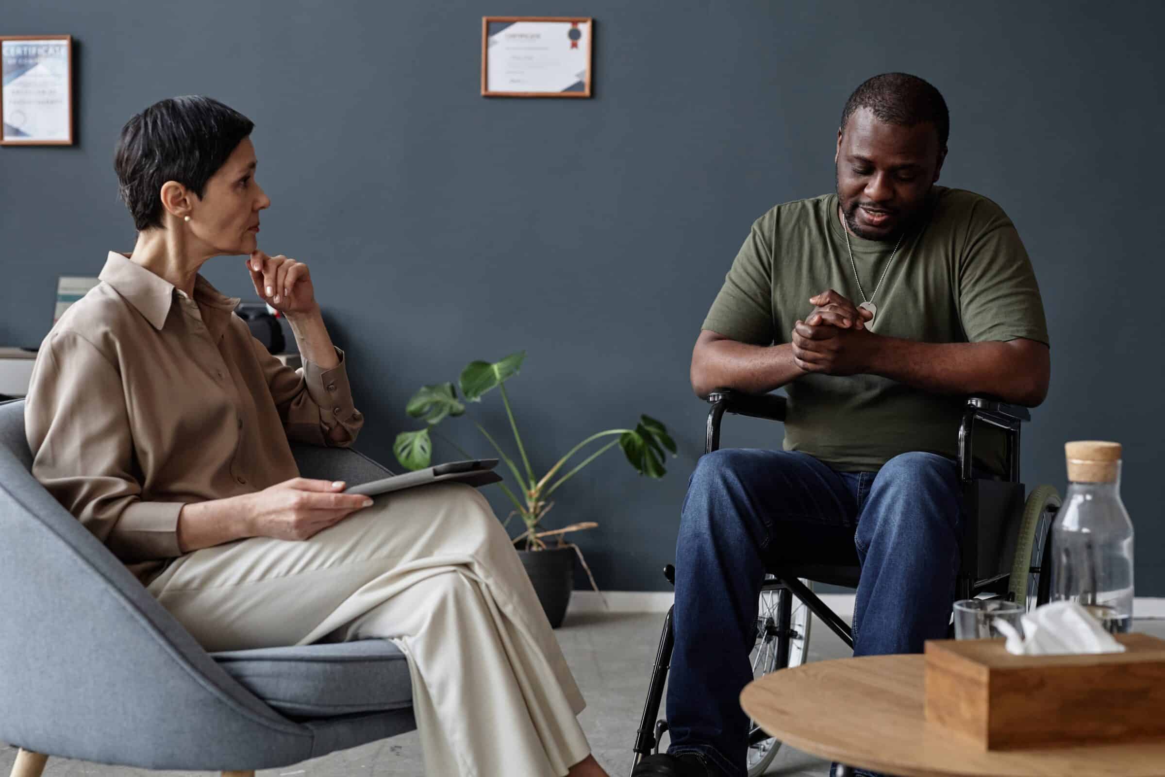 adult male in wheelchair talking to his EDMR therapist