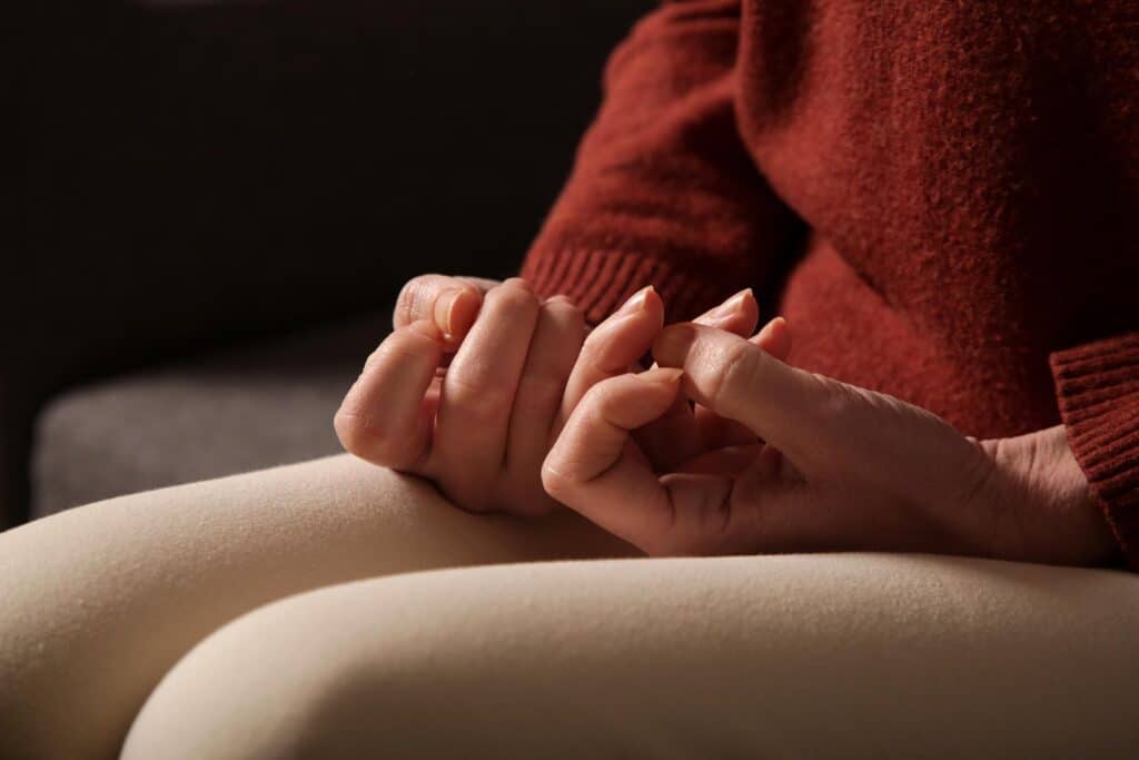 close up hands, picking at cuticles, nervous